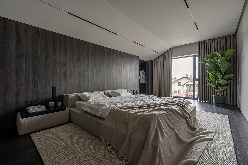Sleek, modern bedroom with dark wooden paneling, recessed lighting, and a large window.
