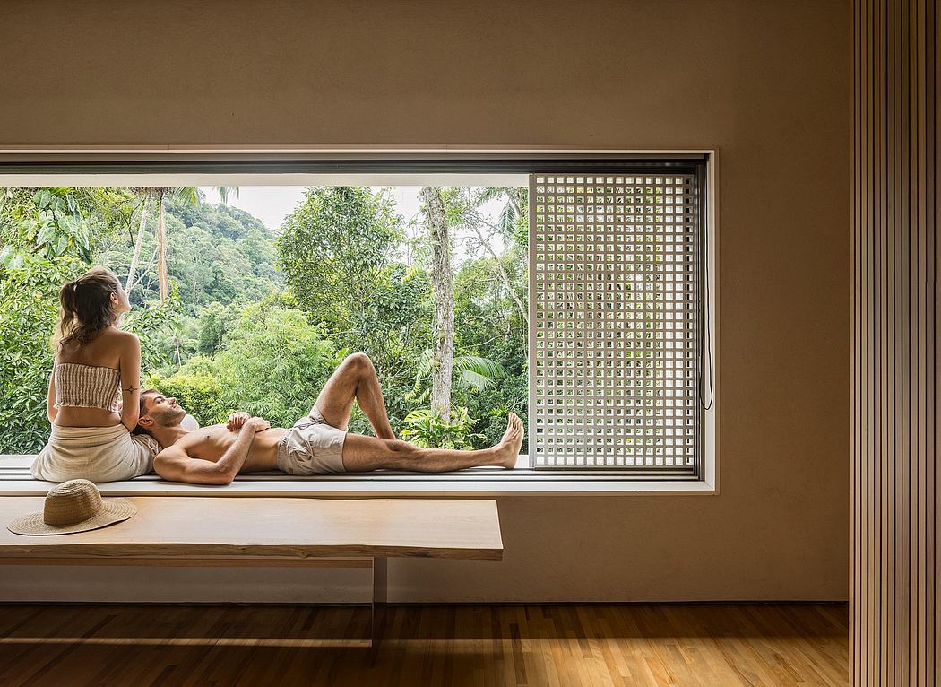 Contemporary interiors with lush jungle views through glass grid windows.