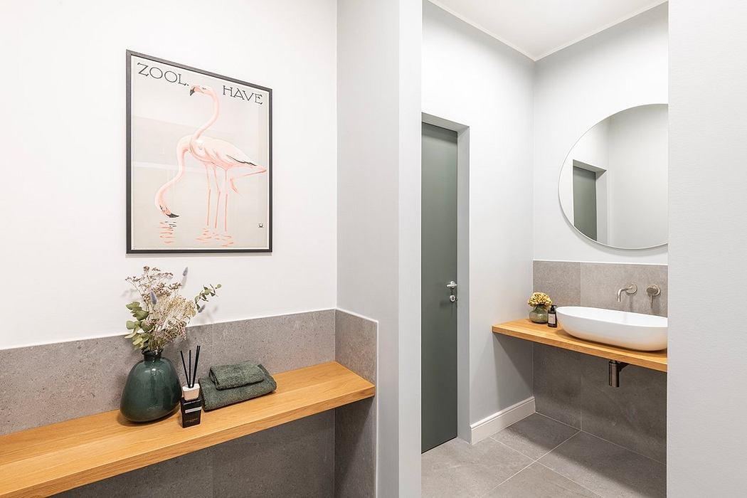 Sleek, modern bathroom with wooden vanity, framed flamingo artwork, and minimalist decor.