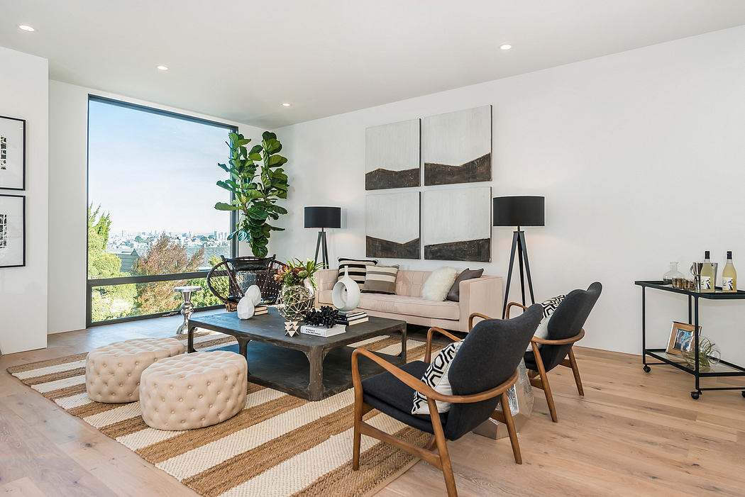 Spacious modern living room with large windows, neutral color palette, and eclectic furnishings.