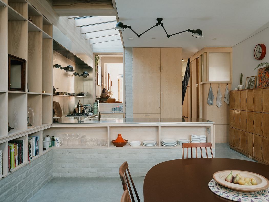 A well-designed kitchen with modern shelving, lighting, and warm wooden accents.