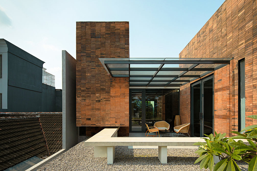 A modern brick and glass building with an open patio area and sleek architectural features.