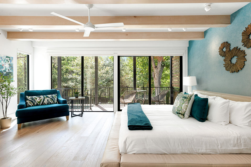 Spacious bedroom with large windows, ceiling fans, and modern, nature-inspired decor.