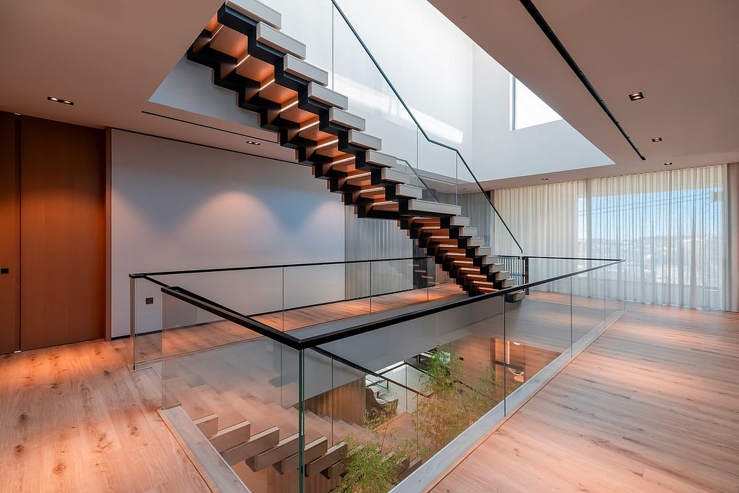 Sleek, minimalist staircase with glass balustrade and suspended wooden treads in modern interior.