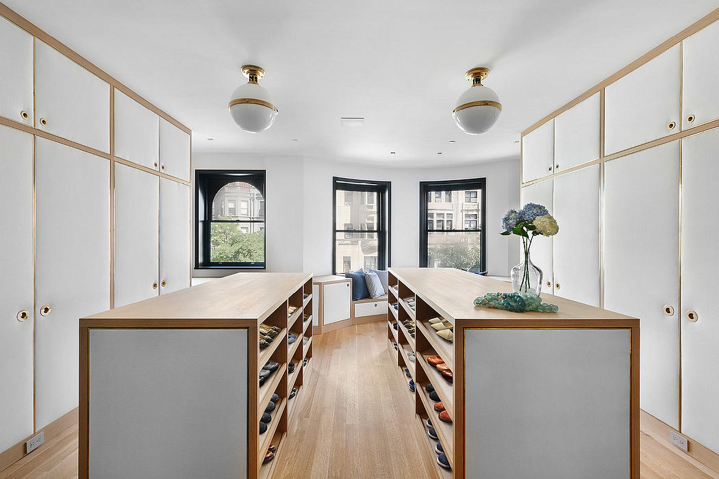 Spacious walk-in closet with ample storage, hardwood floors, and modern lighting.