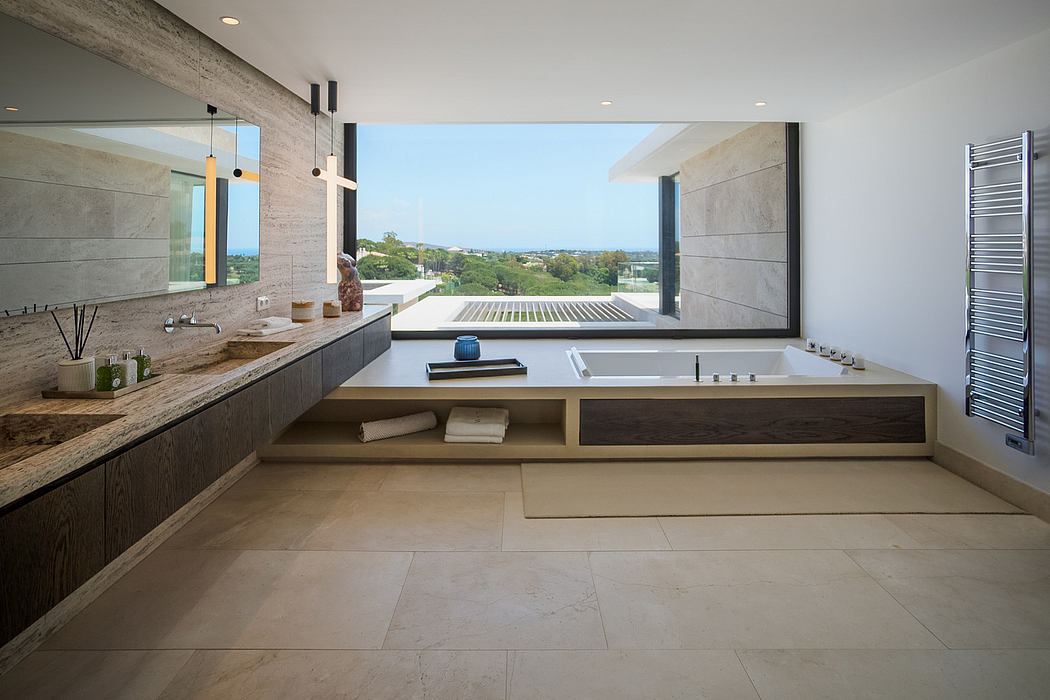 Spacious modern bathroom with concrete walls, raised bathtub, and panoramic window view.