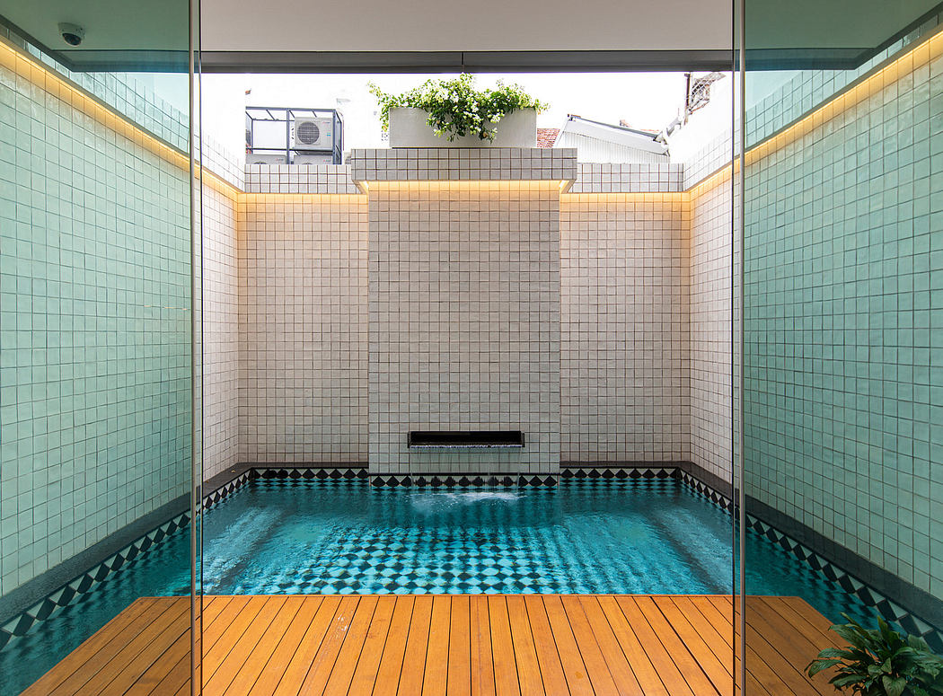 Modern interior with turquoise tile, wood deck, and suspended planter above a pool.