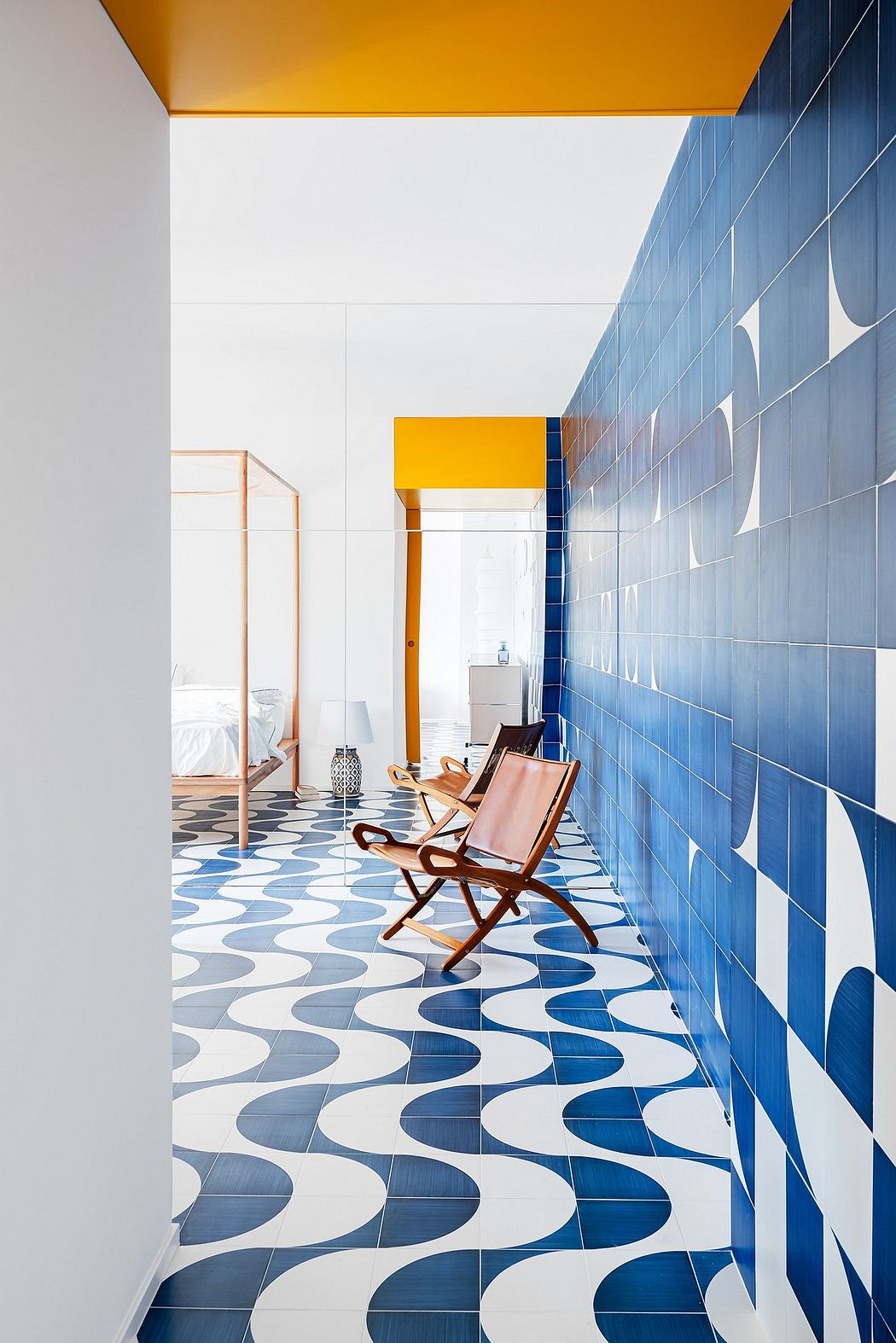 Vibrant blue-tiled walls and patterned flooring create a bold, modern interior design.