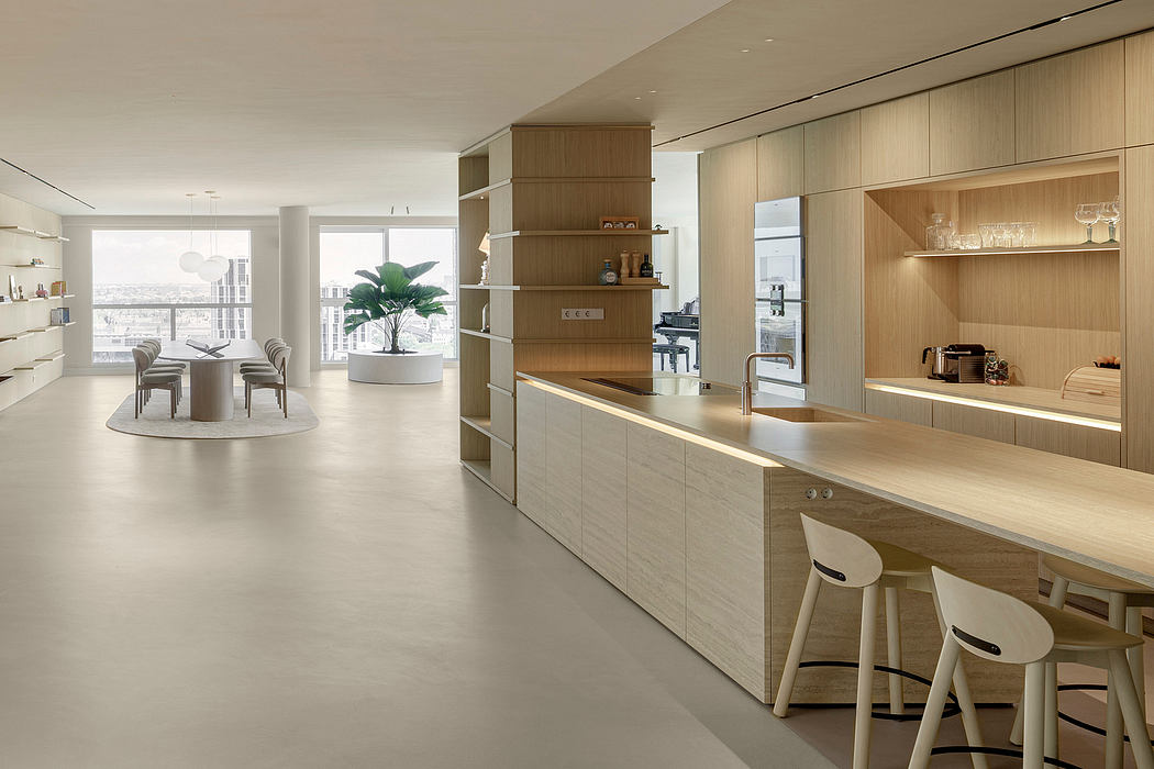 Sleek, minimalist kitchen with warm wood accents, open floor plan, and expansive window view.