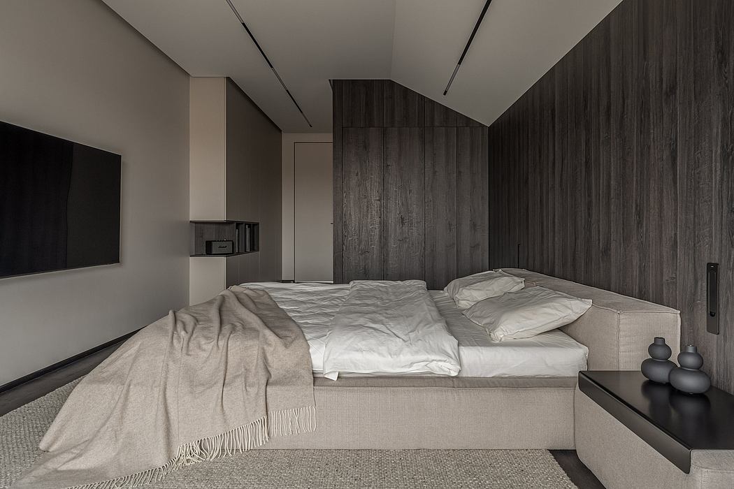 Minimalist bedroom with dark wood panels, floating bed, and decorative accents.