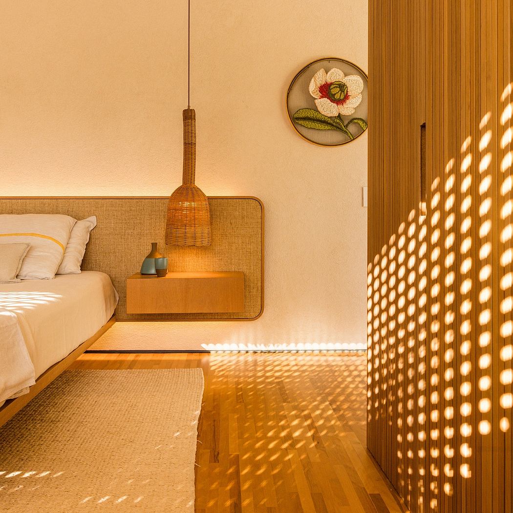 Cozy bedroom with woven light fixture, floral decor, and warm wooden accents.