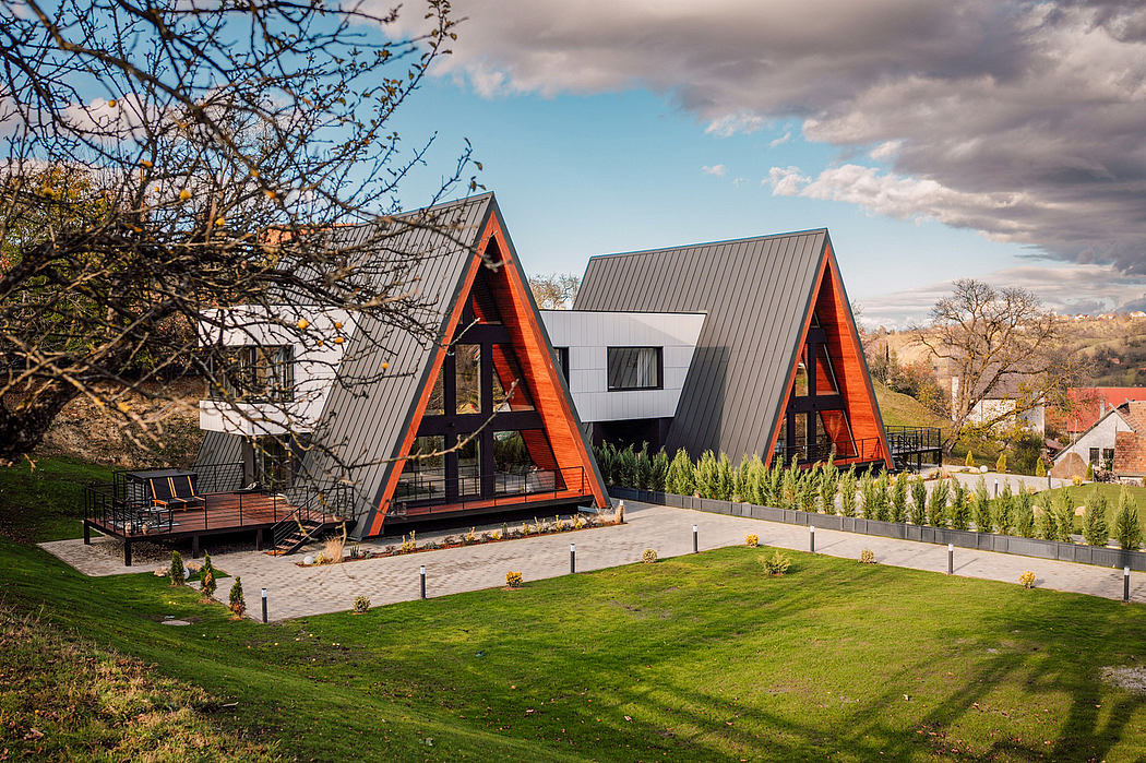 Distinctive A-frame architecture with modern design elements, landscaped grounds, and outdoor seating.