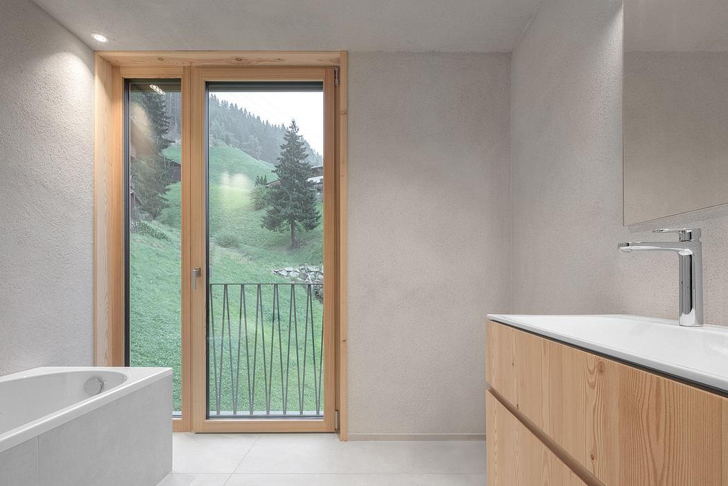 Spacious bathroom with large windows offering scenic mountain views and modern fixtures.