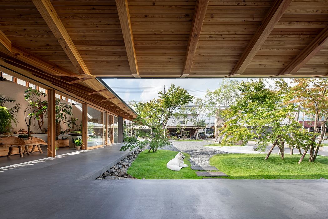 Cozy wooden cabin with expansive glass walls overlooking a lush, landscaped garden.