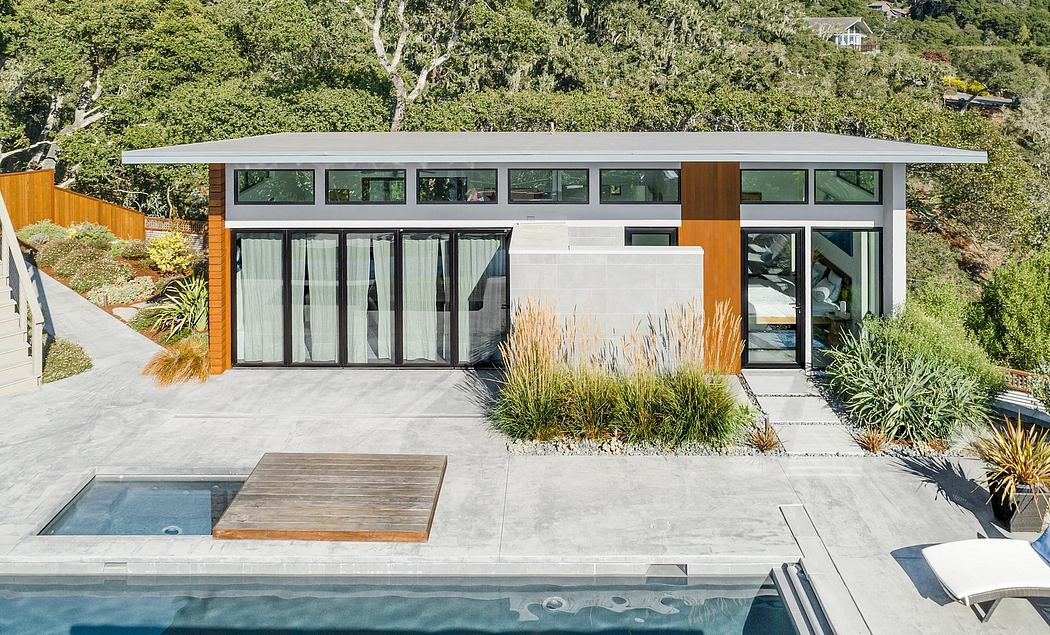 A modern, single-story home with large windows, wooden accents, and a sleek, flat roof design.