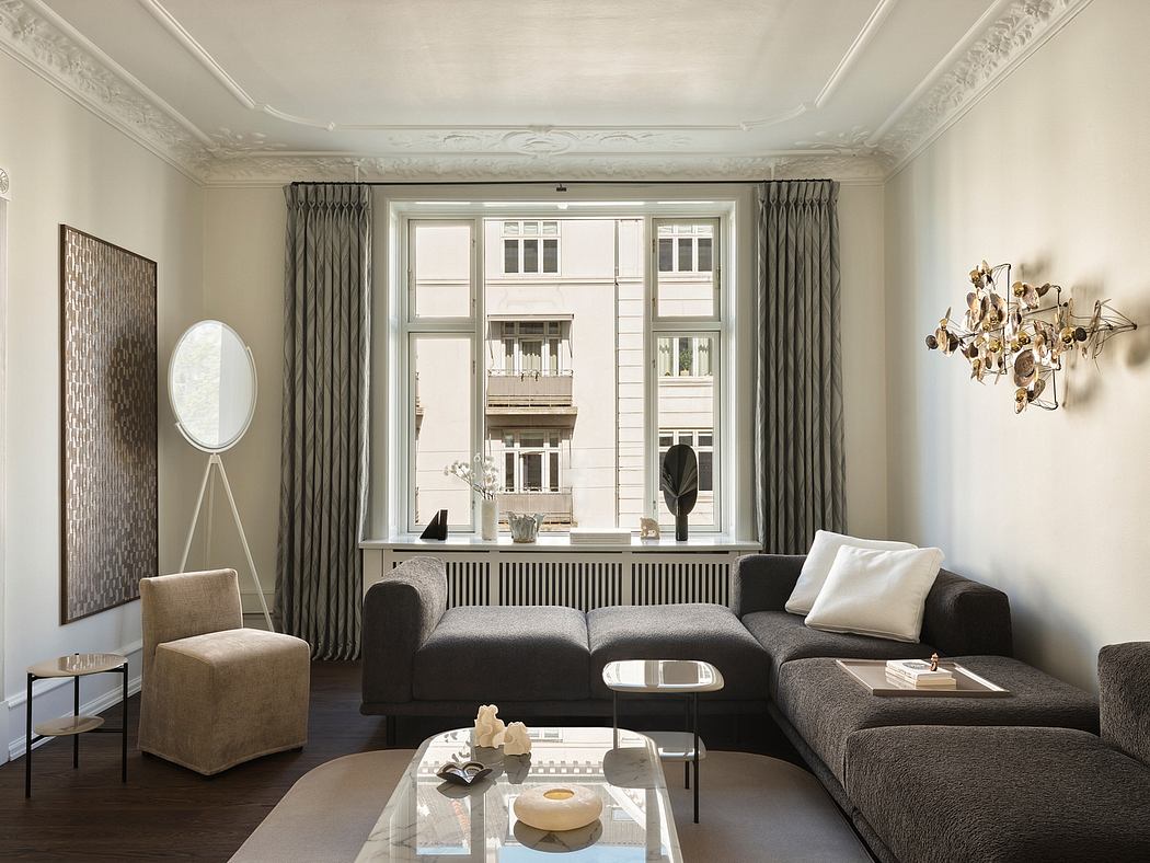 Elegant neoclassical living room with large window, ornate ceiling, and modern furnishings.