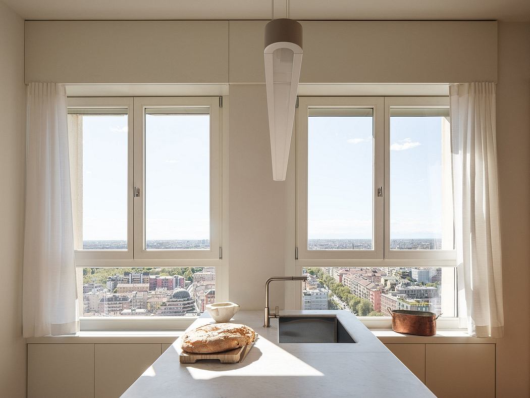 Bright, spacious kitchen with large windows offering panoramic city views.