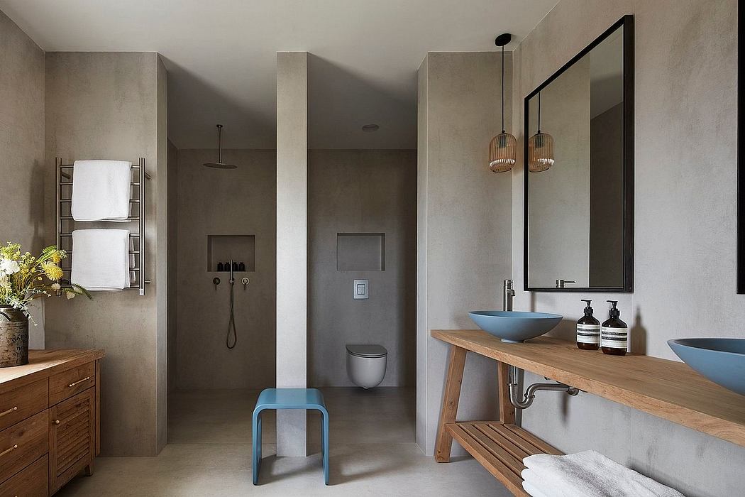 Minimalist bathroom design with concrete walls, wooden vanity, and blue accents.
