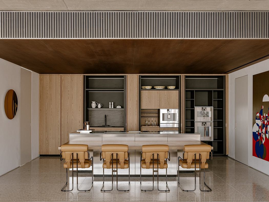 Modern kitchen with sleek wooden cabinetry, minimalist bar stools, and a geometric wall accent.