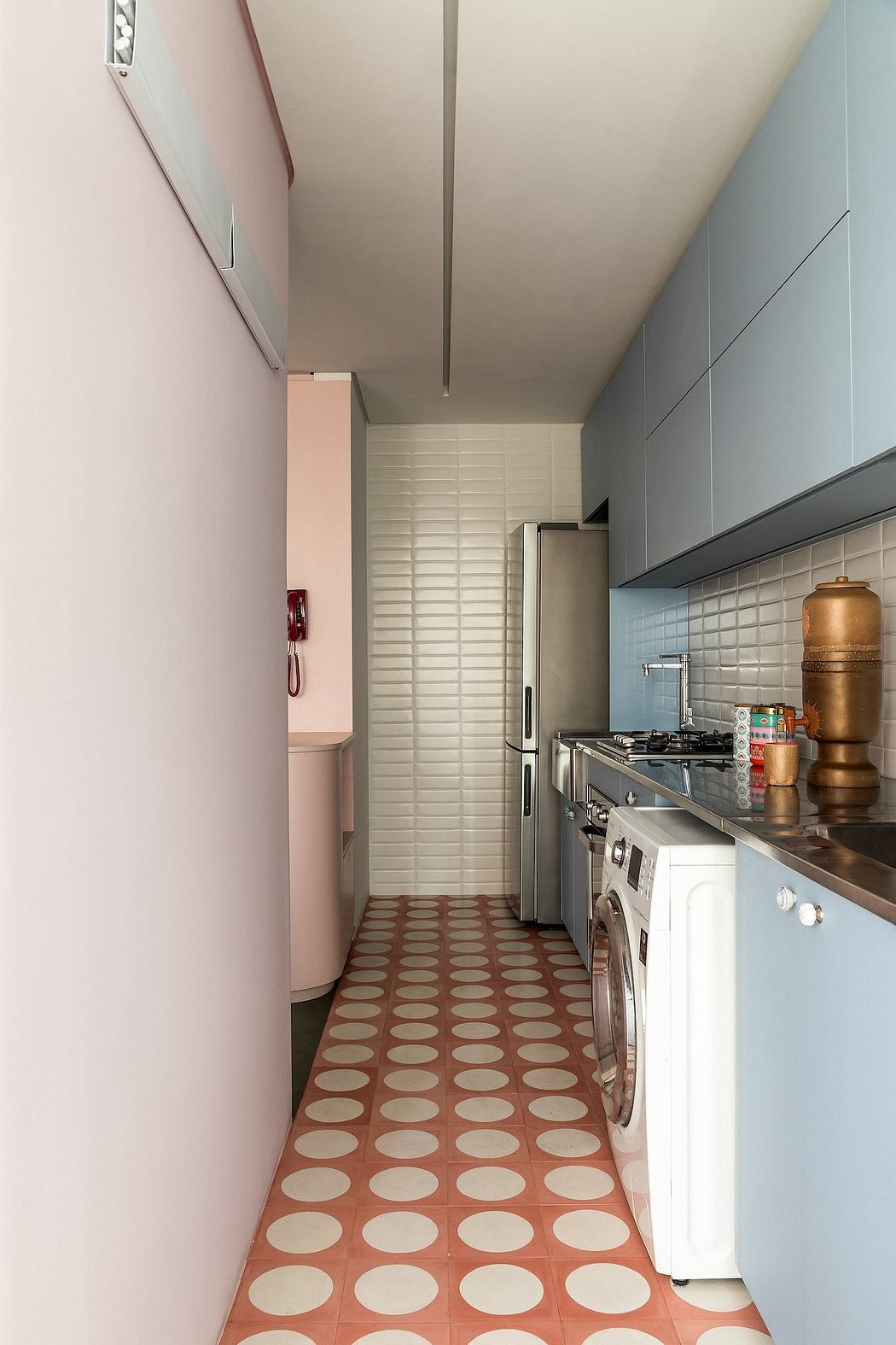 A narrow kitchen with a retro-style checkerboard tile floor, built-in appliances, and a modern, minimalist design.