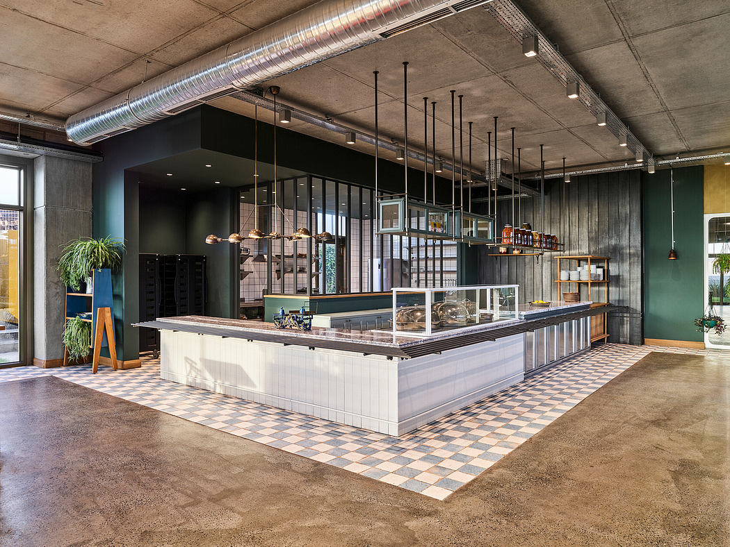 A modern, industrial-style cafe with an open layout, sleek counters, and exposed concrete.