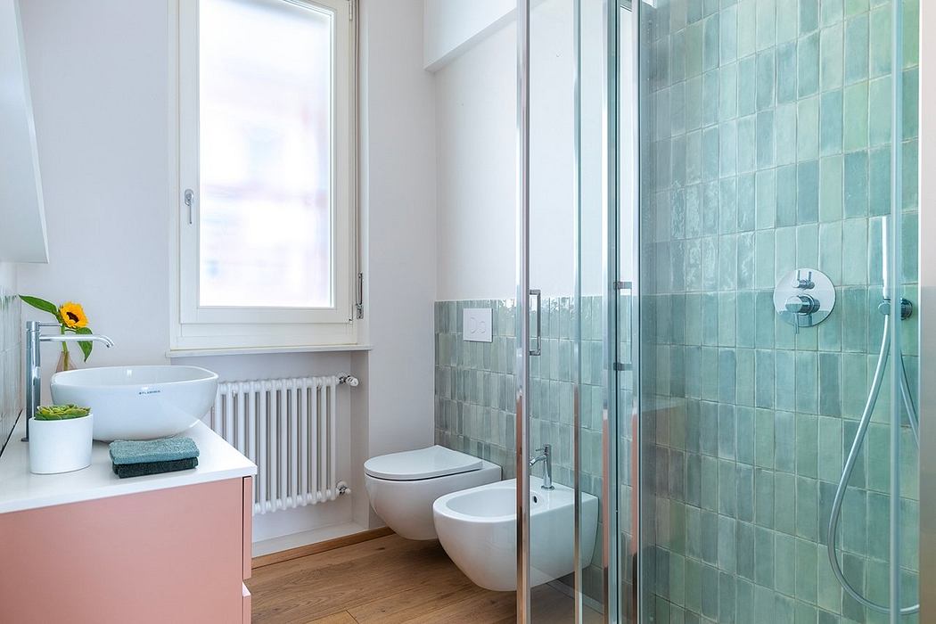 A modern bathroom with a glass shower enclosure, marble tile walls, and a minimalist vanity.