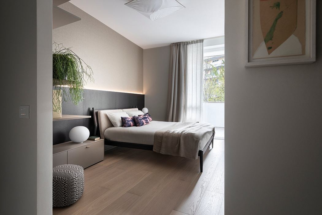 Minimalist bedroom with gray accent wall, floor-to-ceiling curtains, and modern lighting fixture.