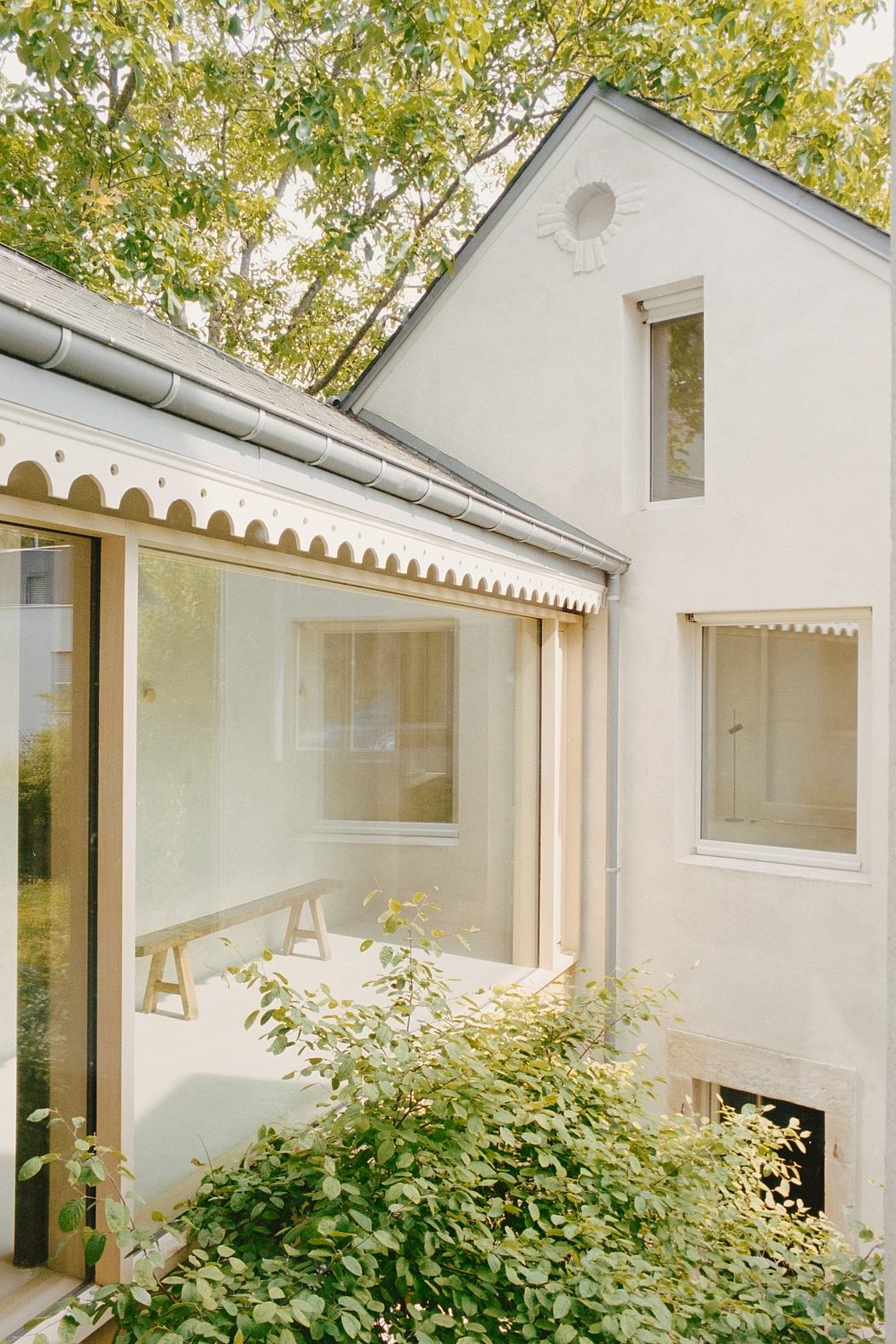 A picturesque cottage nestled among lush foliage, boasting charming architectural features and a cozy ambiance.