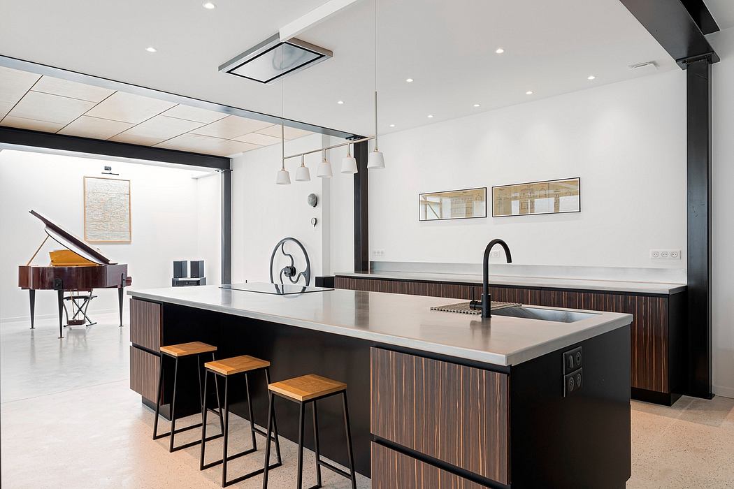 Sleek, modern kitchen with wood-paneled cabinetry, concrete countertops, and pendant lighting.