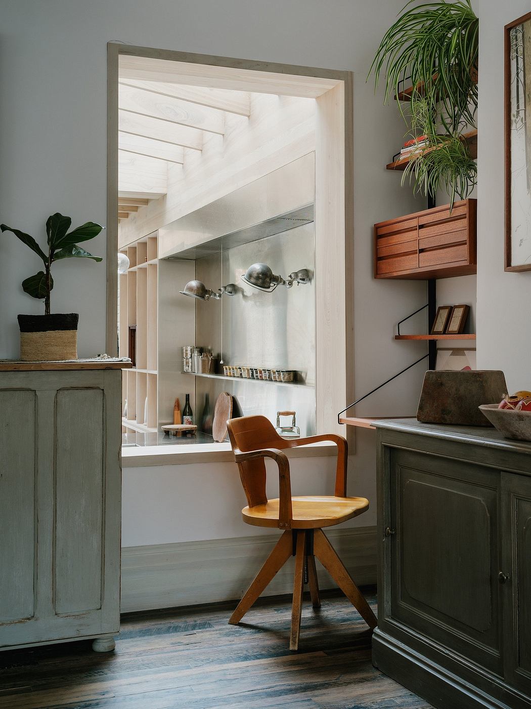 A cozy and modern interior with wooden furniture, built-in shelves, and natural lighting.