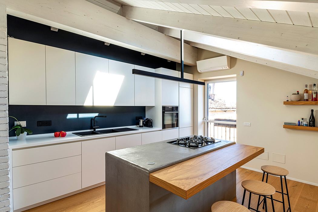 Sleek modern kitchen with white cabinets, wood countertops, and exposed beams.