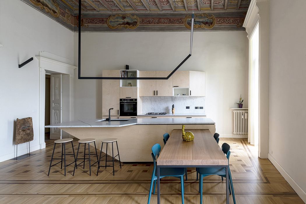 Elegant modern kitchen with ornate historic ceiling, contrasting wooden furniture.