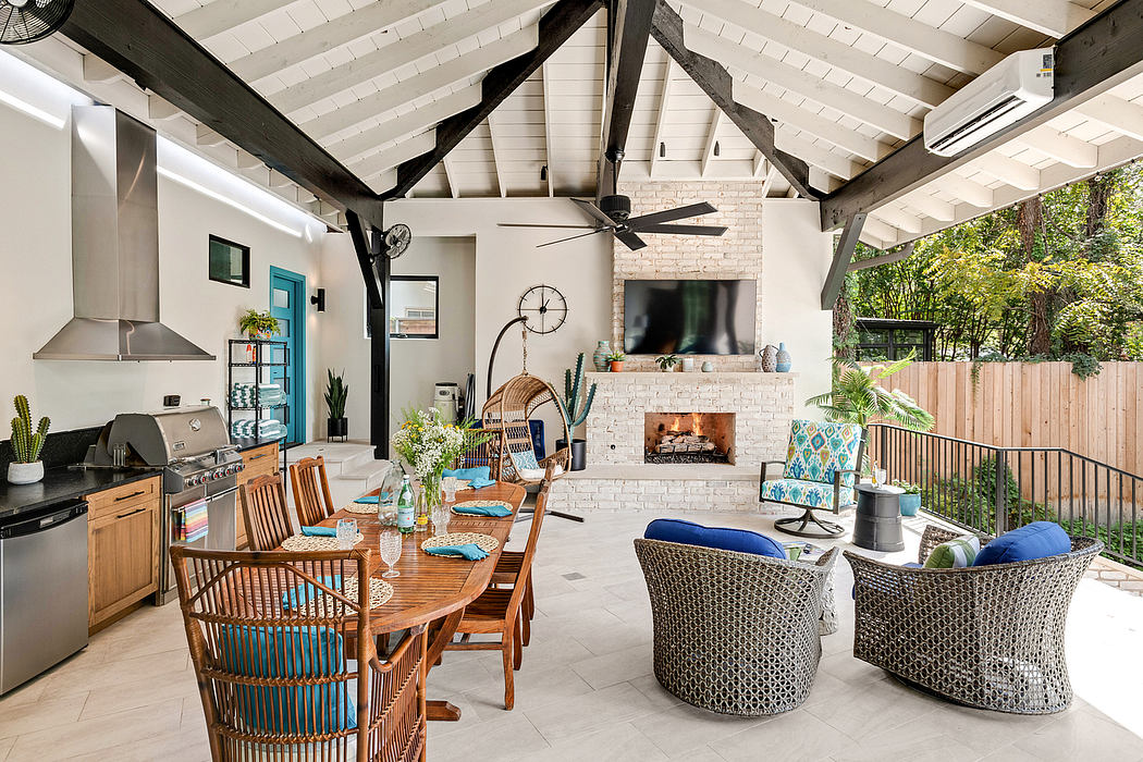 Rustic outdoor living space with exposed beams, brick fireplace, and patio furniture.