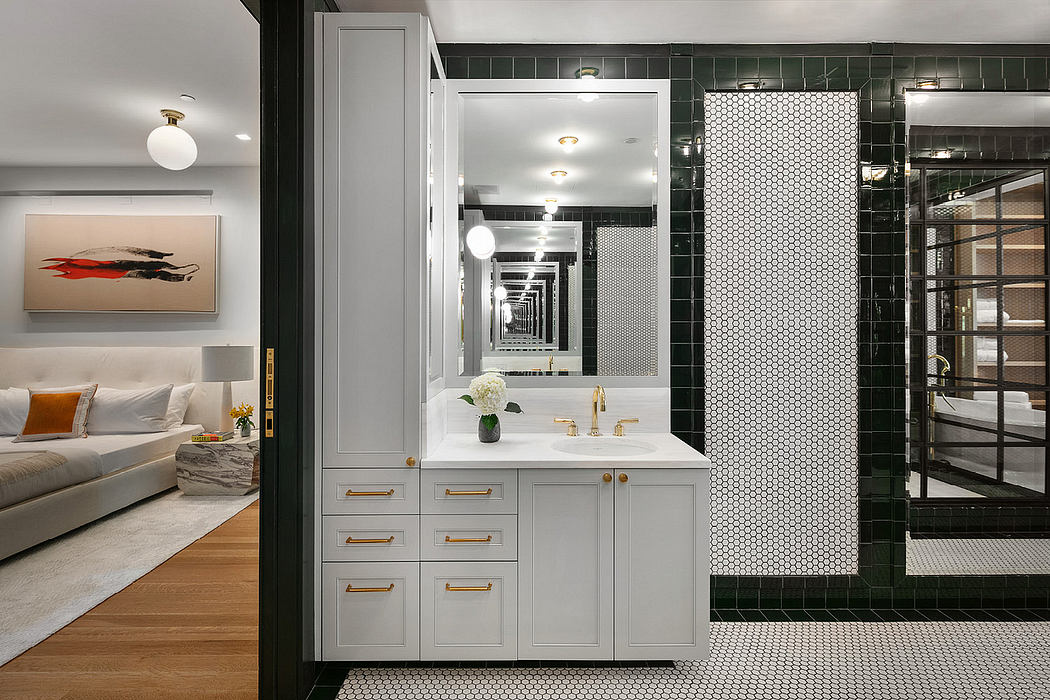 Elegant modern bathroom with sleek white cabinets, black hexagonal tiles, and recessed lighting.