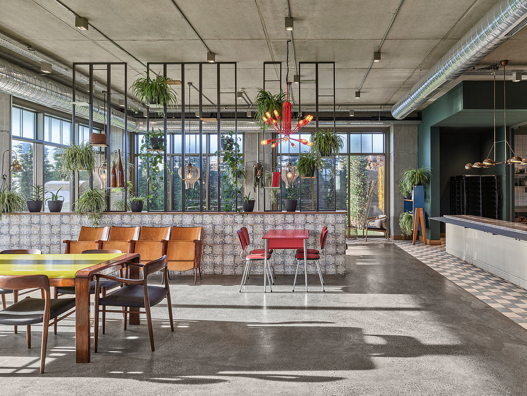 An industrial-style office space with exposed concrete, metal frames, and potted plants.