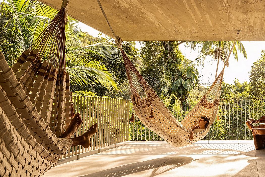 A cozy outdoor lounge with woven hammocks and lush tropical foliage.