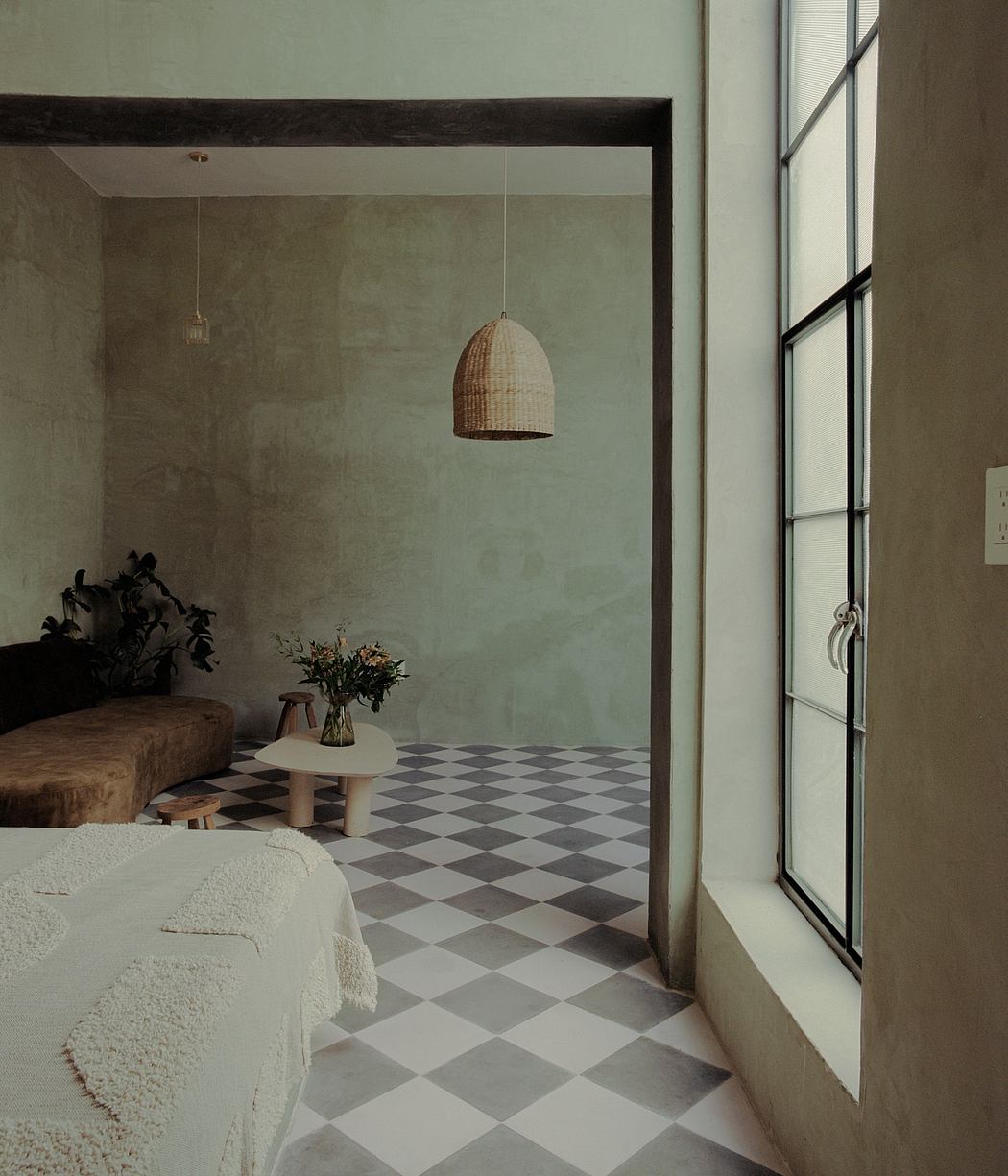 Cozy interior with woven pendant light, checkered tiled floor, and modern furnishings.