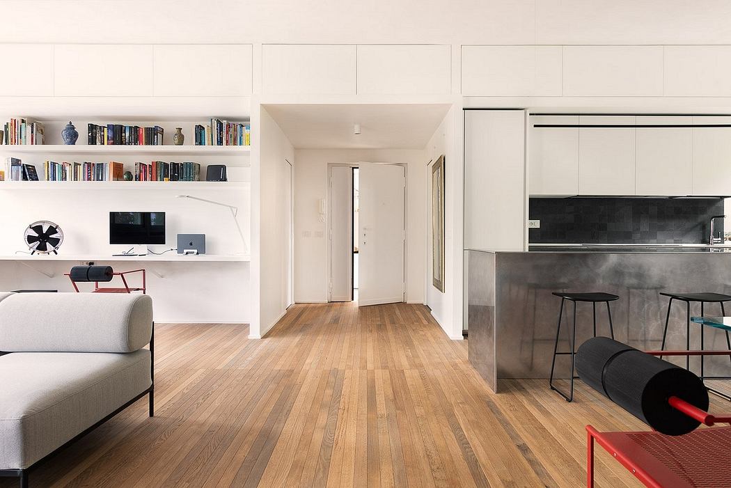 Sleek, open-concept living space with modern furnishings, built-in shelving, and wood flooring.