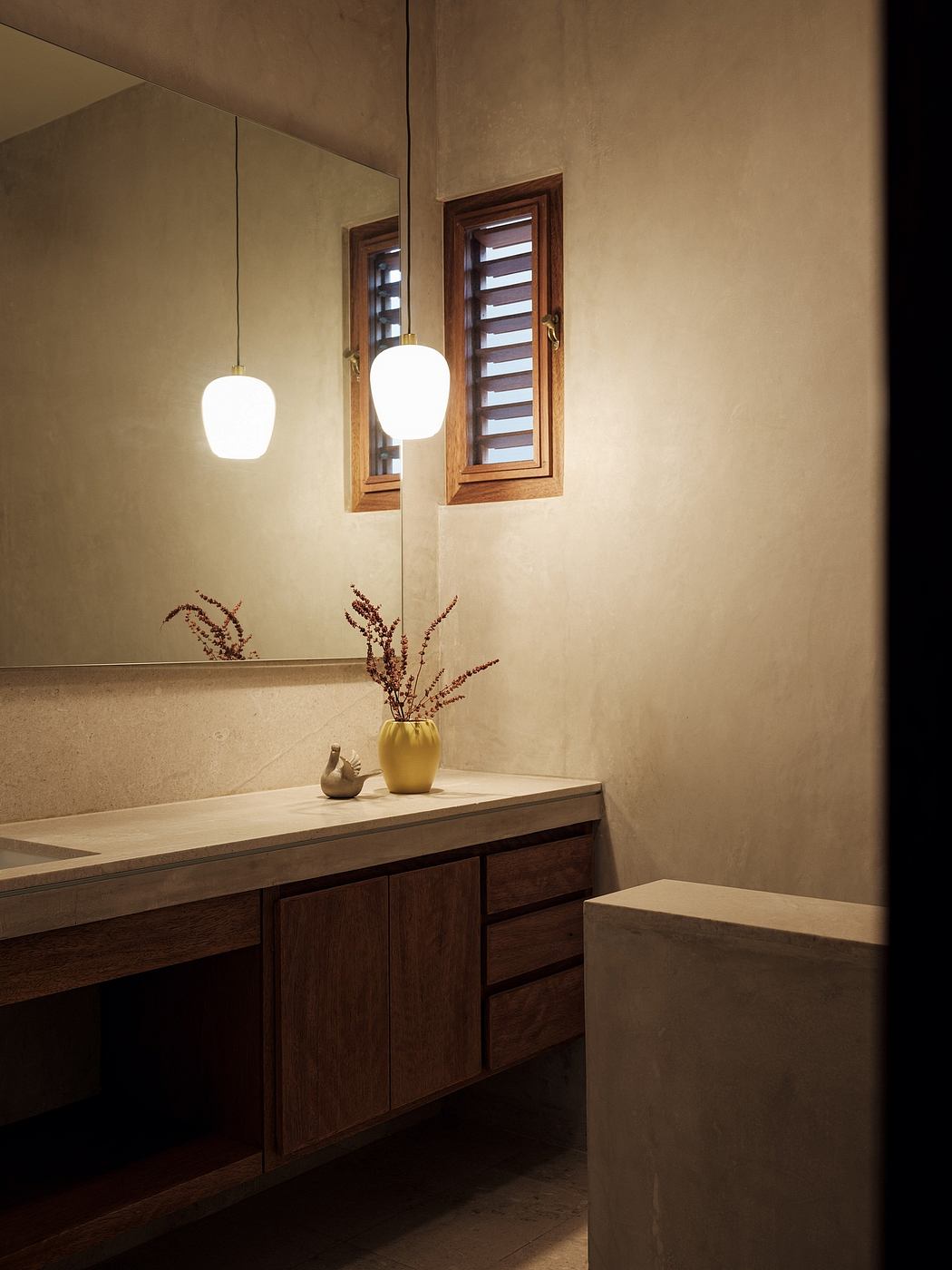 Warm-toned bathroom with wooden vanity, mirror, and pendant lights creating a cozy ambiance.