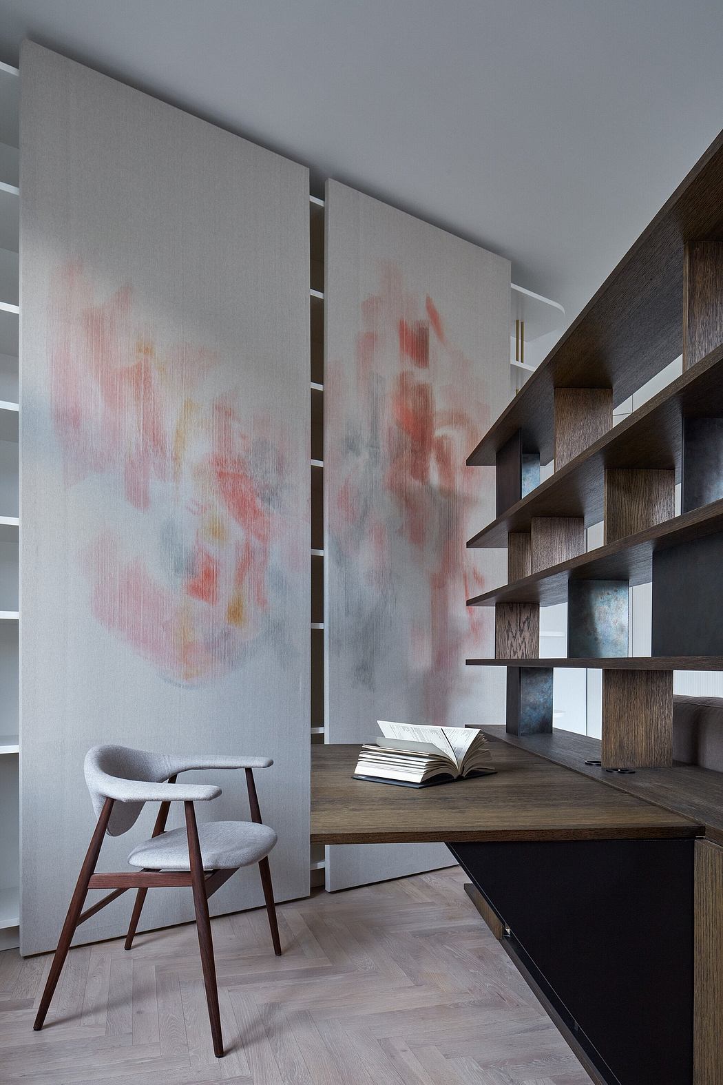 Minimalist home office with modern furniture, shelving, and abstract art on the walls.