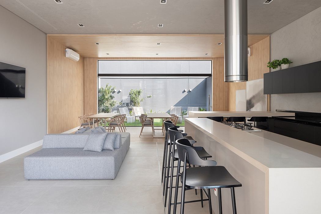 A modern, open-concept living and dining area with a minimalist, wood-paneled design.