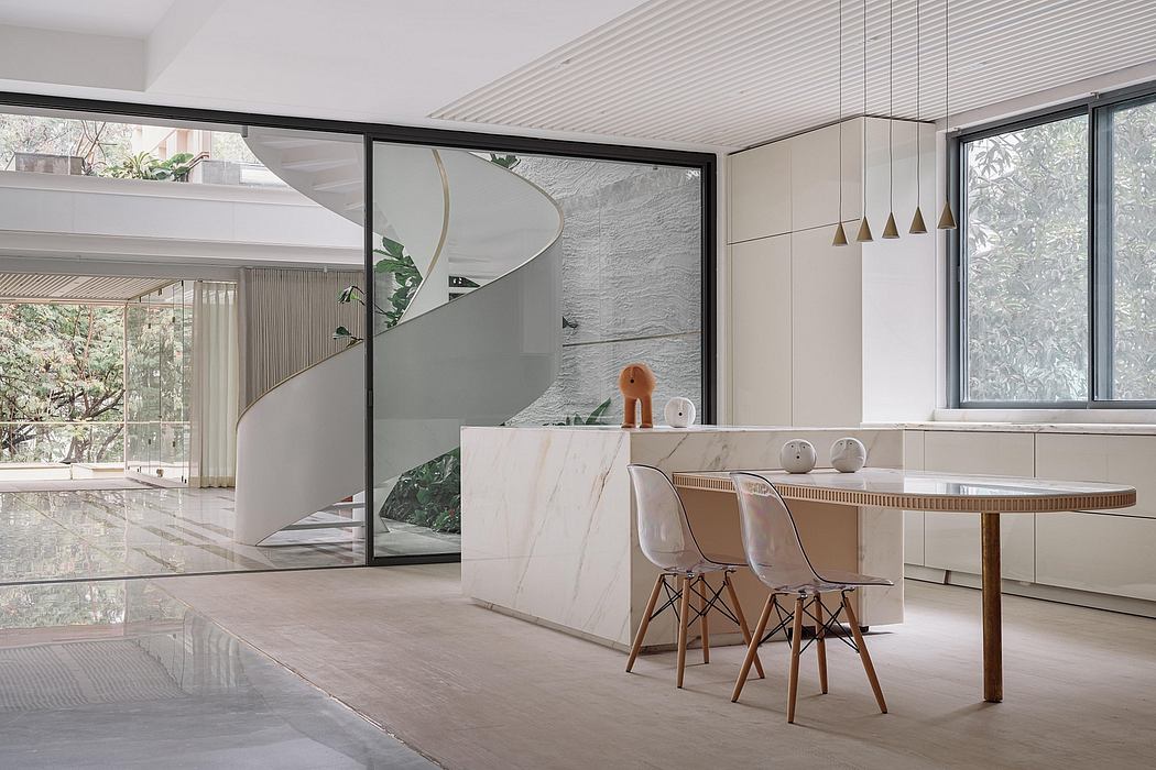 Minimalist interior with spiral staircase, marble countertops, and pendant lighting.