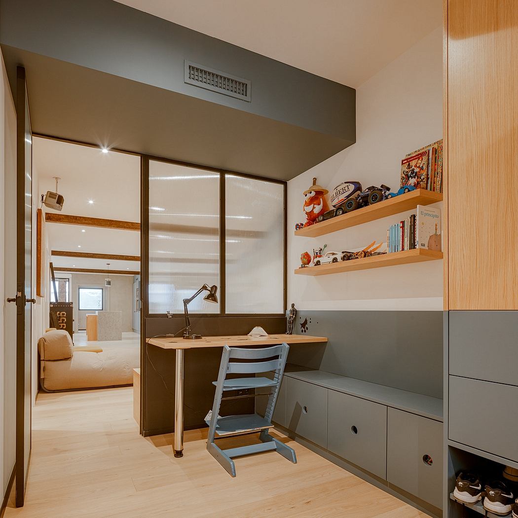 Well-designed bedroom with built-in desk, shelves, lighting, and sliding door access.