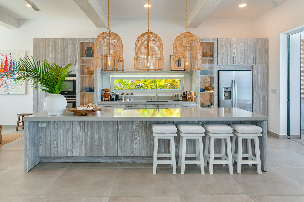 A modern kitchen with a large central island, wood-paneled cabinets, and woven pendant lights.