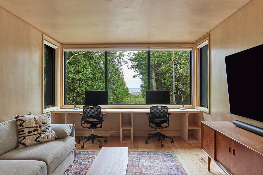 Cozy cabin with expansive forest views, built-in workstations, and mid-century inspired decor.