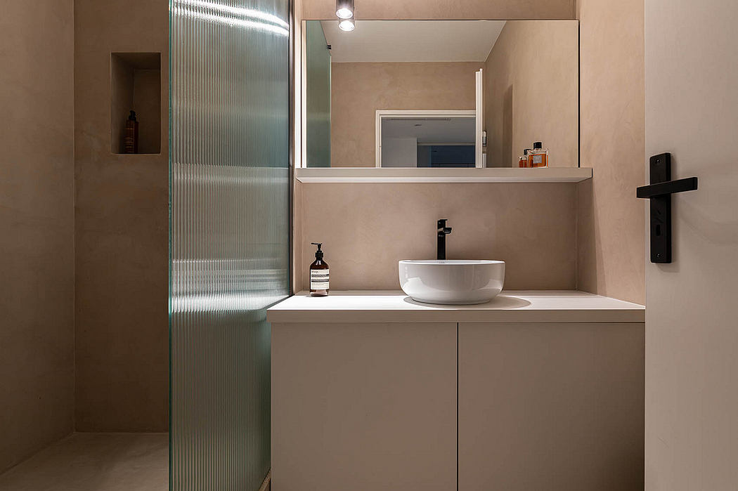 Minimalist bathroom design features a sleek vanity, vessel sink, and glass-enclosed shower.
