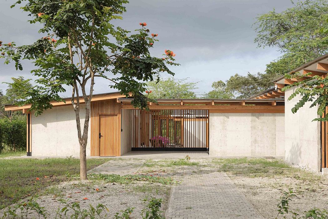 A modern, open-plan structure with wooden accents and a lush outdoor setting.