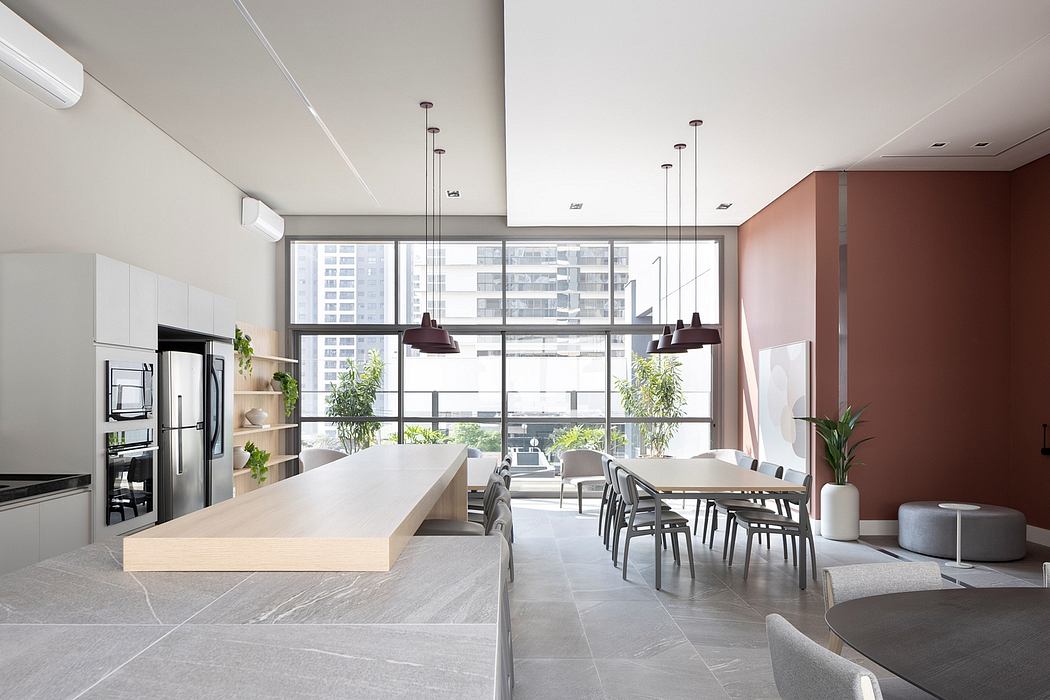 Modern open-concept kitchen with sleek cabinetry, large windows, and minimalist furnishings.