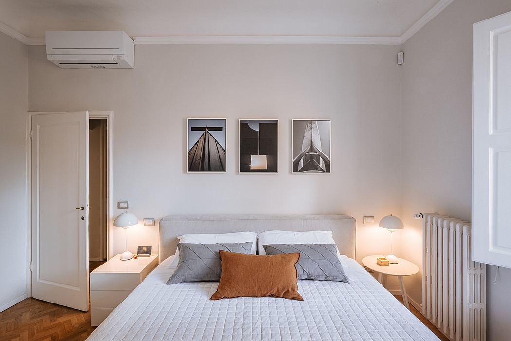 Minimalist bedroom with modern art prints, neutral colors, and functional lighting.