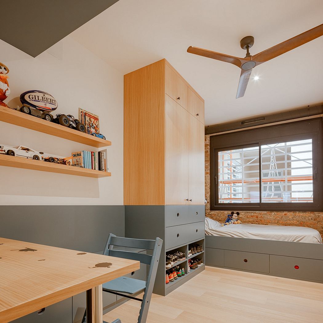 Cozy kids' room with built-in storage, wooden shelves, and a ceiling fan.